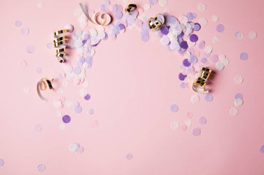 elevated view of violet confetti pieces on pink surface clipart