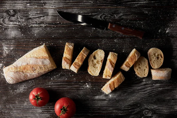 Top View Slices Baguette Tomatoes Knife Wooden Table Covering Flour — Stock Photo, Image