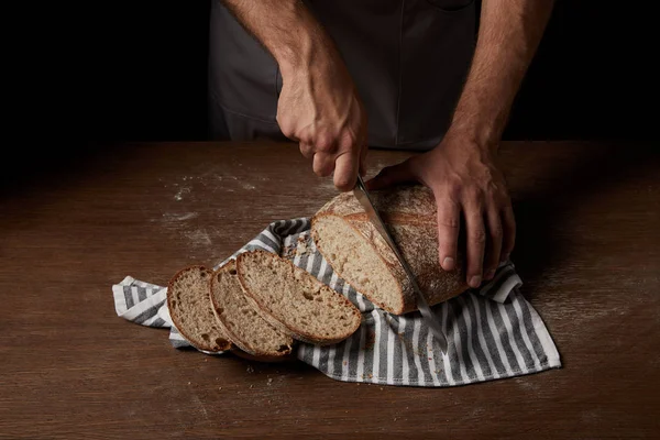 Partial View Male Baker Cutting Bread Knife Sackcloth Wooden Table — Stock Photo, Image