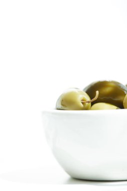 close up view of bowl with  green olives isolated on white background clipart