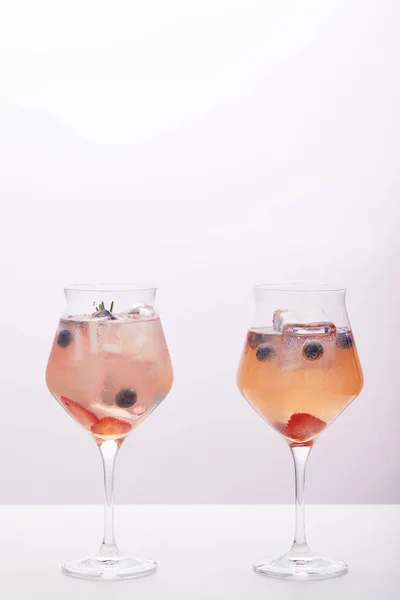 Two Glasses Lemonade Ice Cubes Rosemary Strawberries Blueberries Isolated Grey — Stock Photo, Image