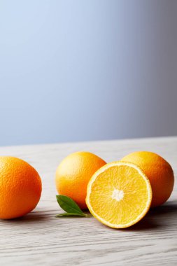 close-up shot of bunch of fresh oranges on wooden surface clipart