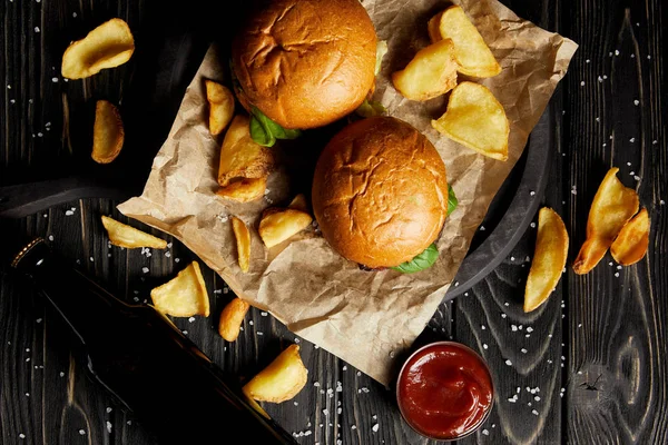 Set of junk food hamburgers and fried potatoes on craft paper