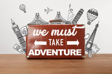 Vintage brown leather travel bag with illustration and inspiration - we must take adventure  clipart