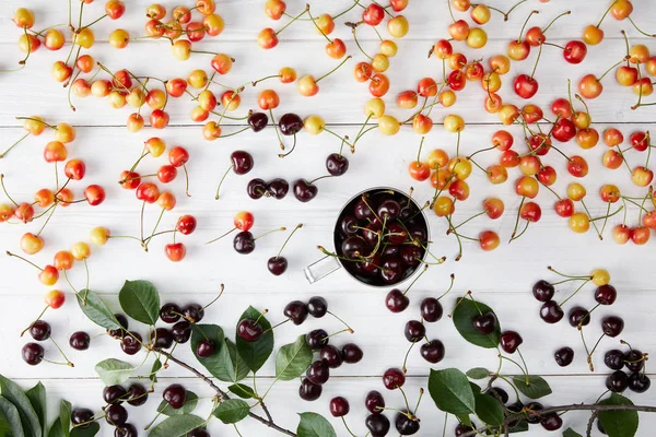 Top View Red Rainier Sweet Cherries Cup Spilled White Wooden — Stock Photo, Image