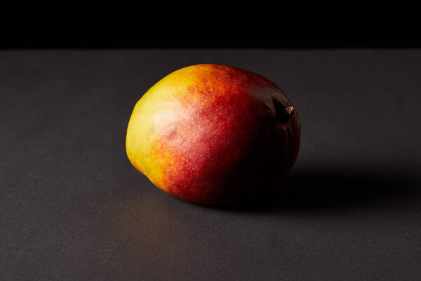 fresh ripe mango on black background 