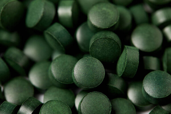 full frame image of pile of spirulina pills background 