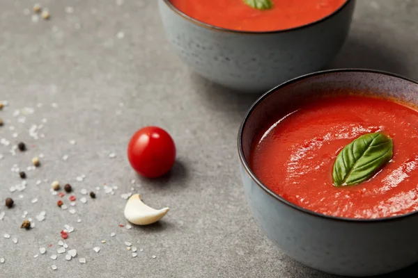Cooked tomato soup in plates and tomato with garlic on grey table — Stock Image Cooked Tomato Soup Plates Tomato Garlic Grey Table Stock Photo