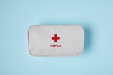 top view of white first aid kit bag on blue surface clipart