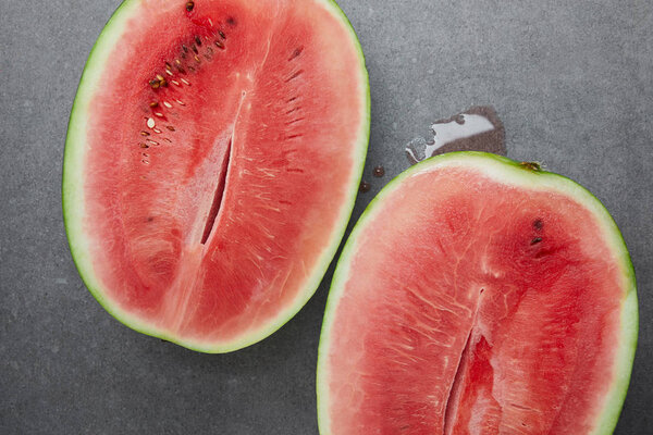 top view of ripe watermelon pieces on grey concrete tabletop