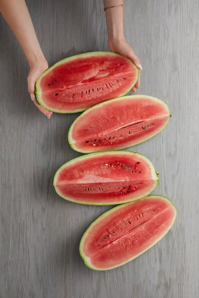 Cropped Shot Female Hands Fresh Watermelon Slices Grey Wooden Surface — Stock Photo, Image