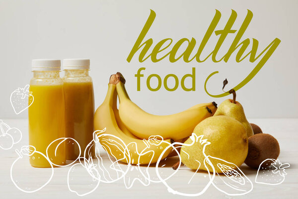 yellow detox smoothies in bottles with bananas, pears and kiwis on white background, healthy food inscription