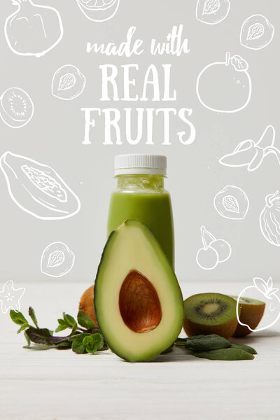 green detox smoothie with avocado, kiwi and mint on white wooden surface, made with real fruits inscription