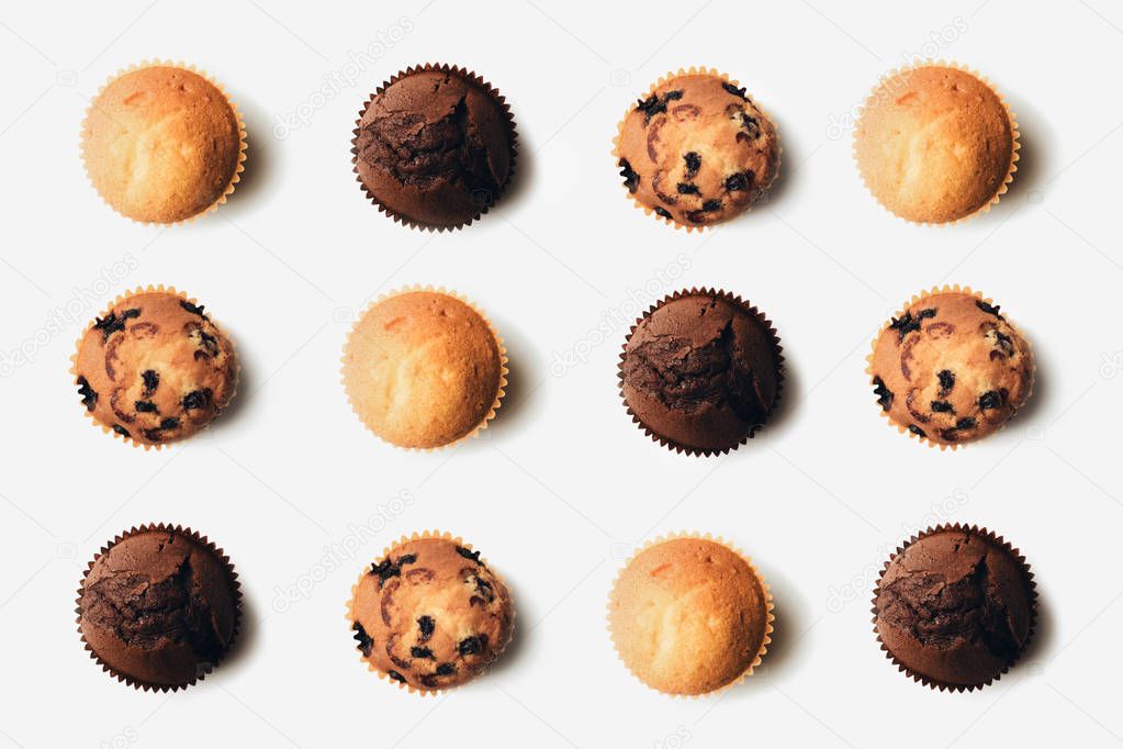 top view of arranged freshly baked delicious muffins on white