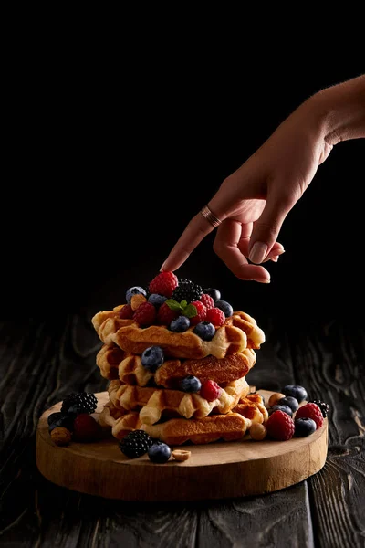 Cropped Shot Woman Touching Stack Belgian Waffles Berries Black Wooden — Free Stock Photo