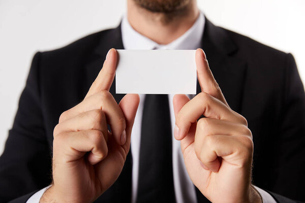 partial view of businessman presenting blank business card isolated on white background 