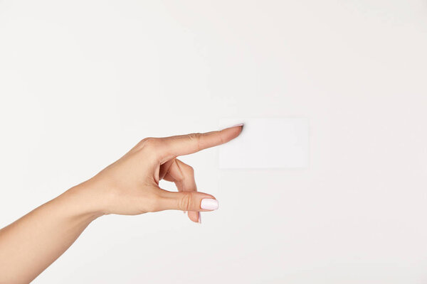 partial view of businesswoman showing blank business card isolated on white background