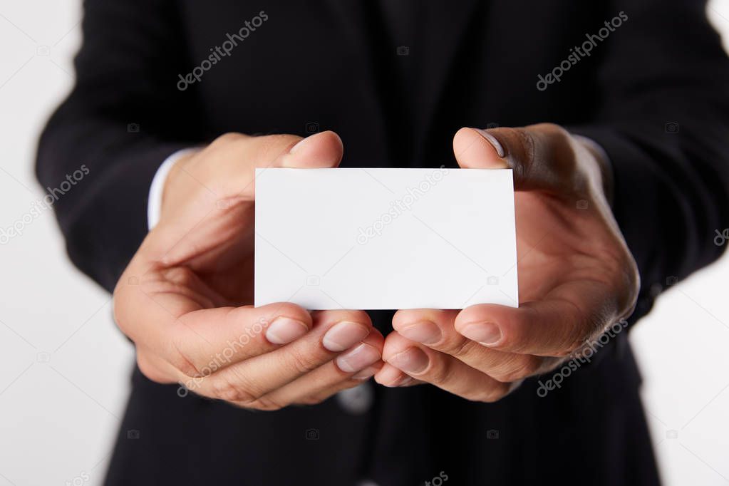 partial view of businessman presenting empty business card isolated on white background 