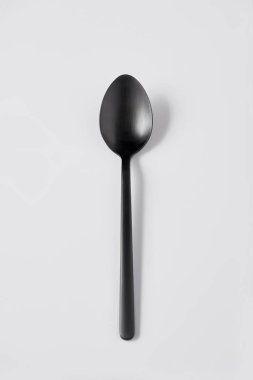 elevated view of black spoon on white background, minimalistic concept clipart