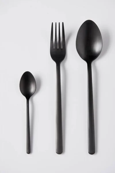 Elevated View Black Spoons Fork White Background Minimalistic Concept — Stock Photo, Image