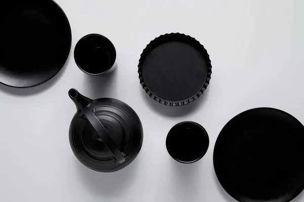 Top View Black Teapot Plates Baking Dish Cups White Table — Stock Photo, Image