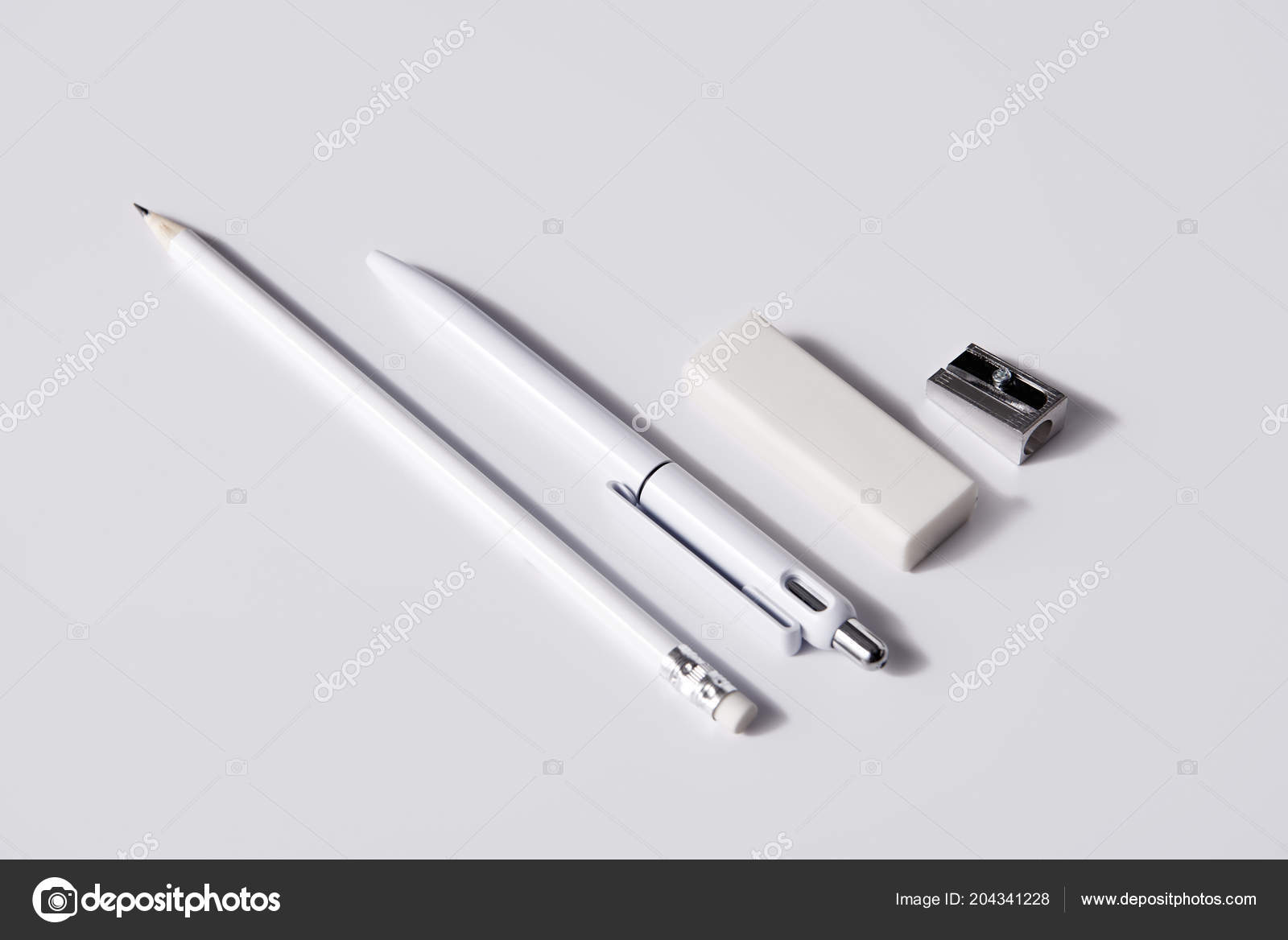 Download Close Shot Pen Pencil Eraser Sharpener Row White Surface Mockup Stock Photo By C Antonmatyukha 204341228