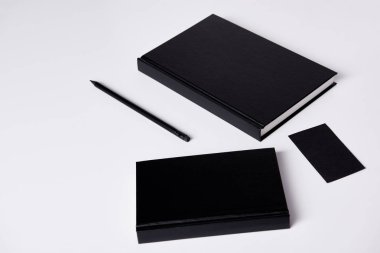 close-up shot of black notebooks  on white surface for mockup clipart