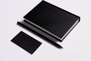 siyah defter ile kalem ve kartvizit izometrik görünümü mockup için beyaz masa '