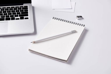 close-up shot of notebook and pencil at workplace on white surface clipart