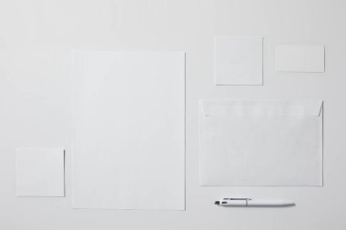 mockup için beyaz yüzeyi kalem ile çeşitli kağıt nesnelerin üstten görünüm