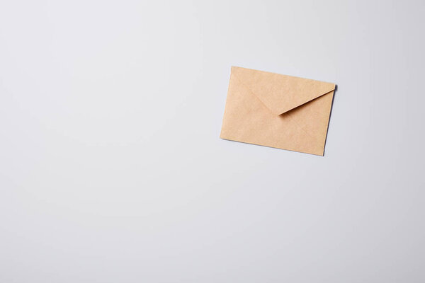 top view of blank brown envelope on white surface for mockup