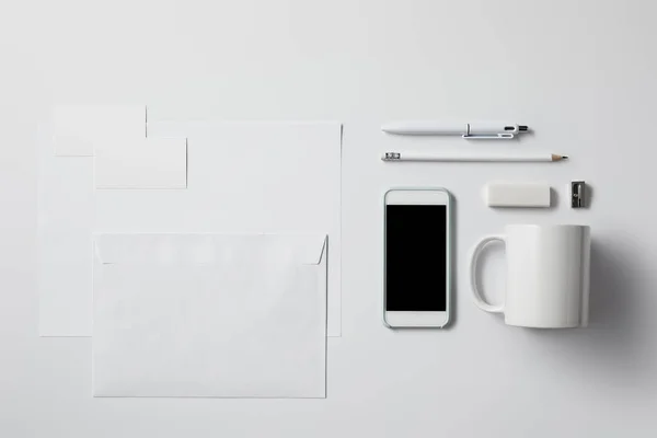 Top View Smartphone Various Supplies Blank Papers White Surface Mockup — Stock Photo, Image