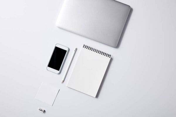 top view of arranged various business workplace objects on white surface for mockup