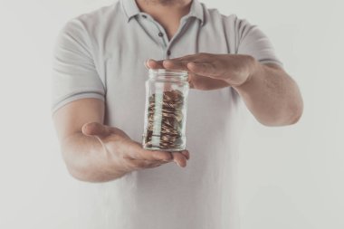 cropped image of man holding jar of coins in hands isolated on white, saving concept  clipart