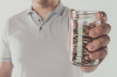 cropped image of man holding jar of coins isolated on white, saving concept clipart