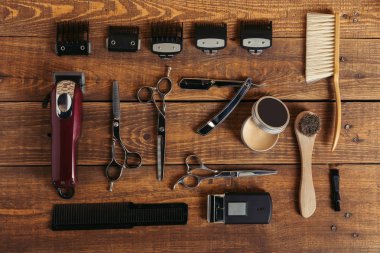 top view of various professional barber tools on wooden surface in hair salon   clipart