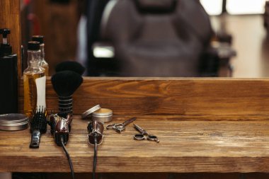 barber tools on wooden shelf and mirror in barbershop clipart