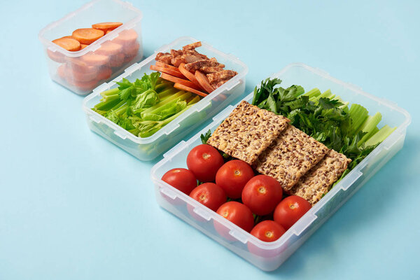 close up view of arrangement of food containers full of fresh healthy food background