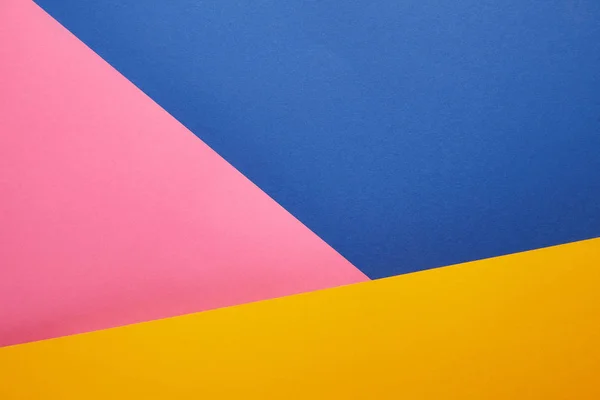 geometrical texture with blue, pink and yellow papers