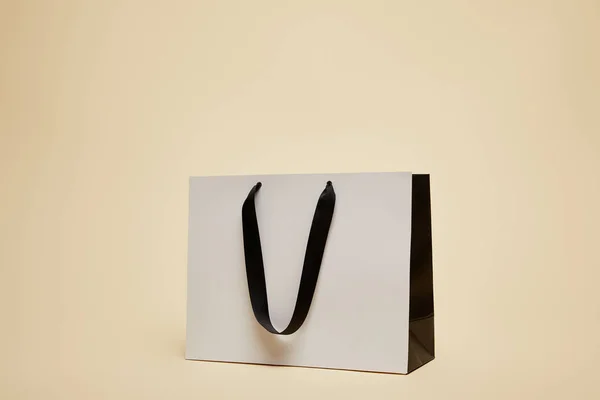 One White Shopping Bag Isolated Beige — Stock Photo, Image