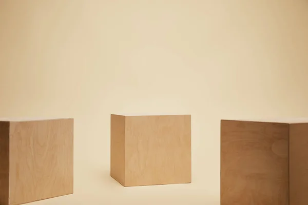 Three Brown Wooden Cubes Isolated Beige — Stock Photo, Image