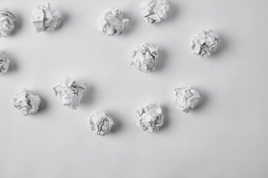 top view of spilled crumpled papers on white surface clipart