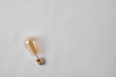 top view of vintage incandescent lamp on white surface clipart