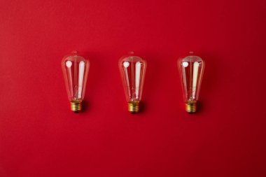 top view of row of vintage incandescent lamps on red tabletop clipart