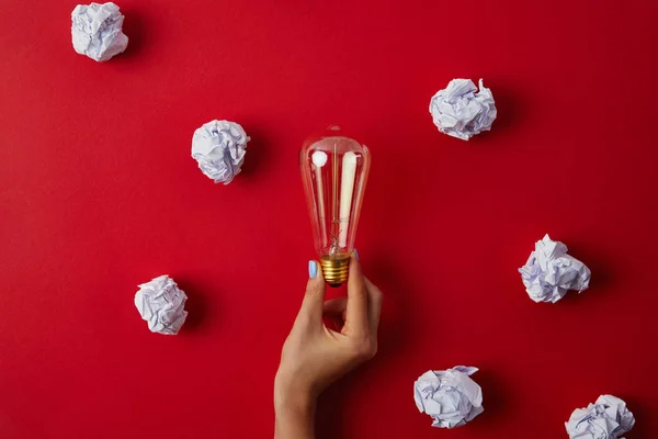 Cropped Shot Woman Holding Vintage Incandescent Lamp Surrounded Crumpled Papers — Stock Photo, Image