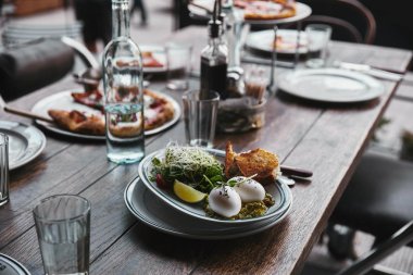 healthy salad and pizza on table at modern restaurant clipart