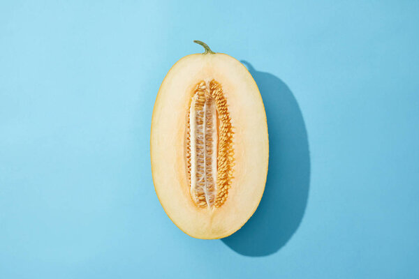 top view of fresh ripe sweet melon on blue background 