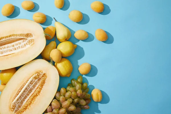 Top View Fresh Ripe Melon Pears Apricots Lemons Grapes Blue — Stock Photo, Image