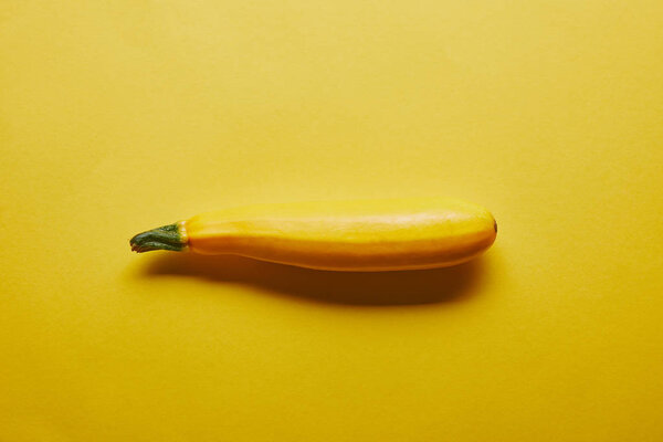 Raw squash vegetable on yellow background