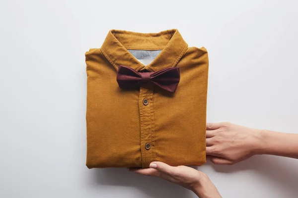 Cropped Image Woman Holding Brown Shirt Bow Tie White — Stock Photo, Image